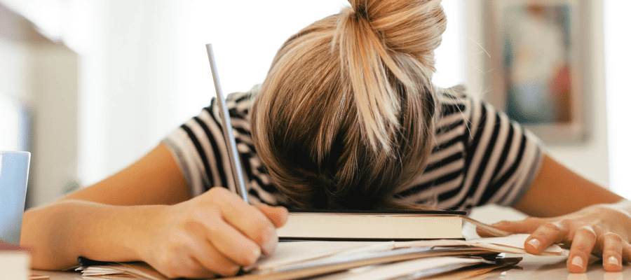 A student with their head on their desk