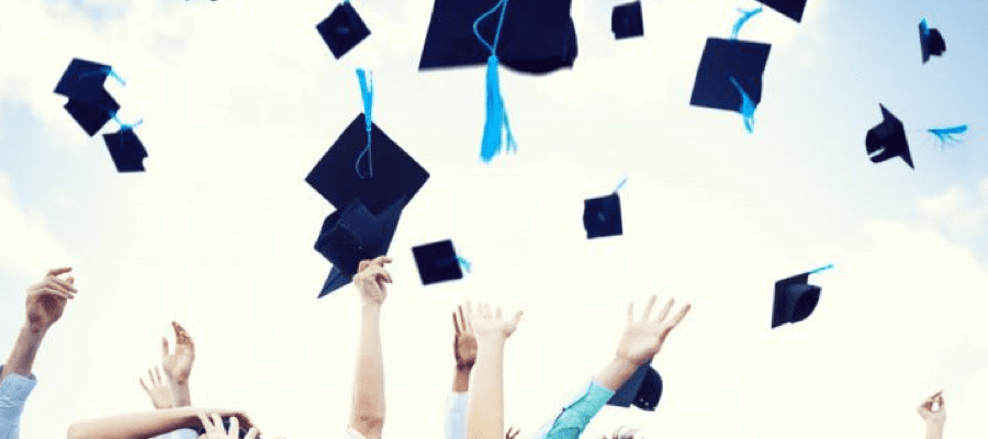 Graduation caps being thrown in the air