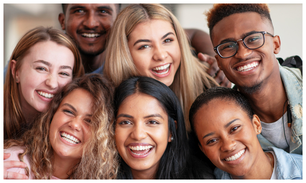 A group of students smiling in a huddle